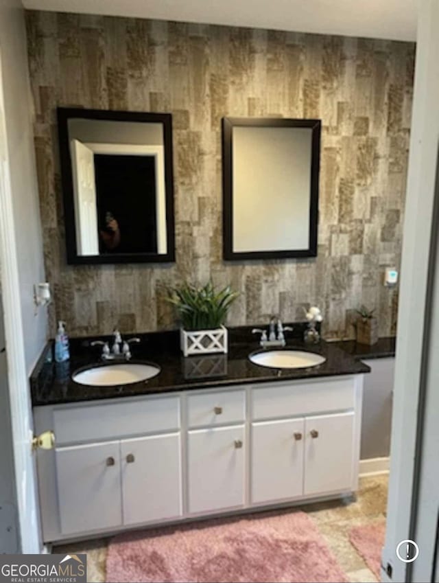 full bath featuring a sink and double vanity