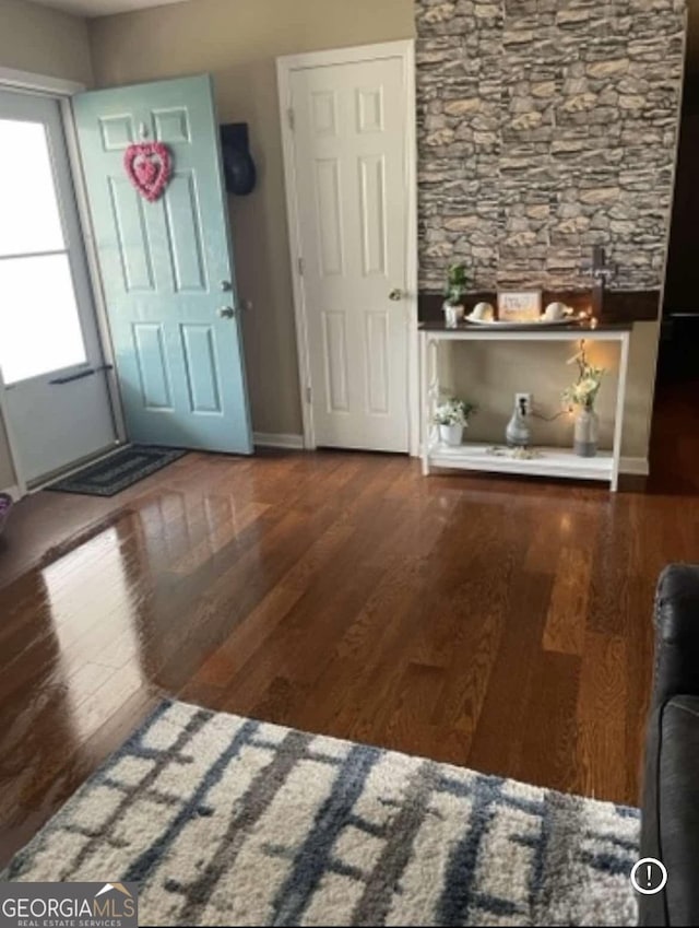 entrance foyer featuring baseboards and wood finished floors