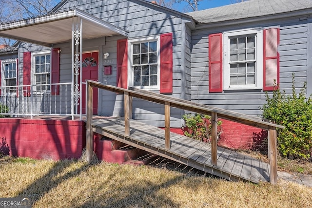 exterior space featuring covered porch and roof with shingles