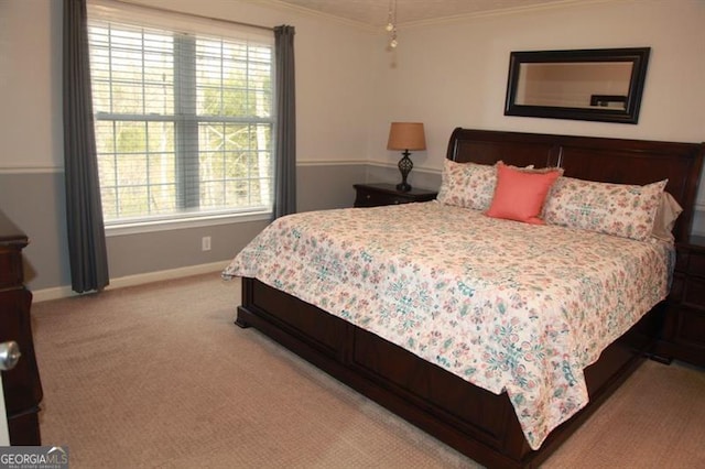 bedroom with light carpet, baseboards, and crown molding