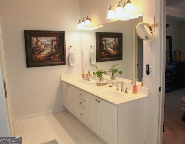 bathroom featuring double vanity, baseboards, a sink, and tile patterned floors