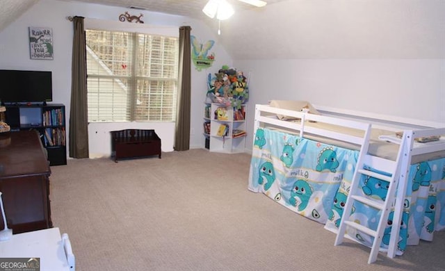 bedroom featuring carpet floors and lofted ceiling