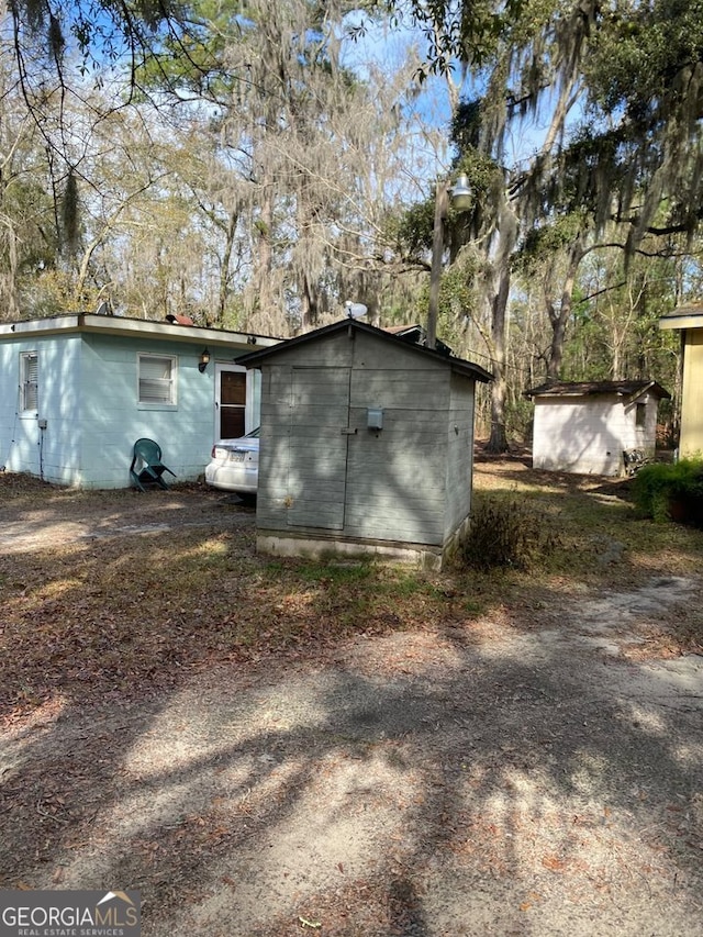 154 Buckhalter Rd, Savannah, GA 31405 - back of house featuring an outdoor structure and a storage shed