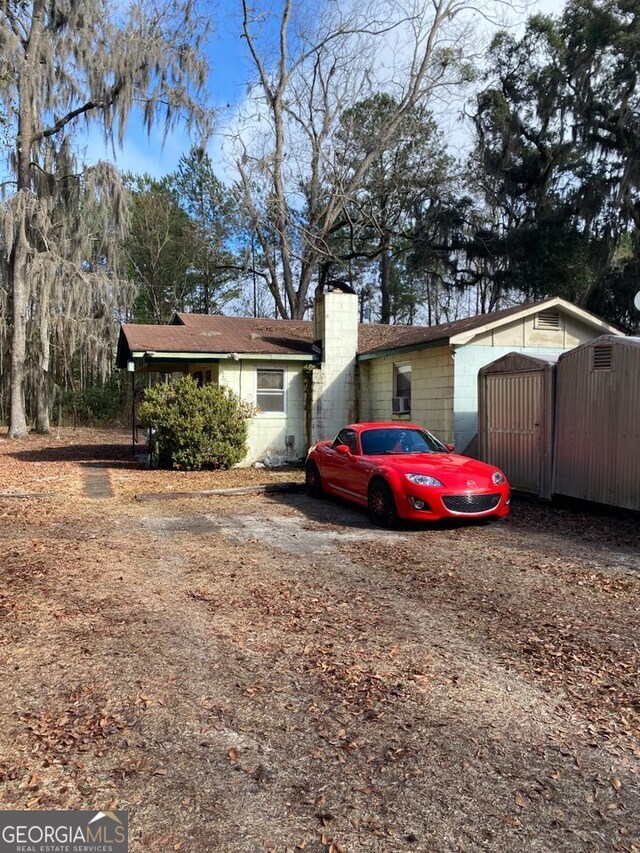 154 Buckhalter Rd, Savannah, GA 31405 - view of front of home with concrete block siding and a chimney