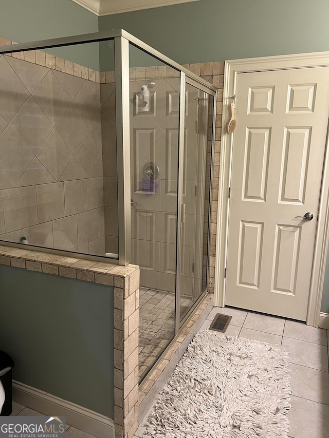 full bath featuring a stall shower and tile patterned flooring