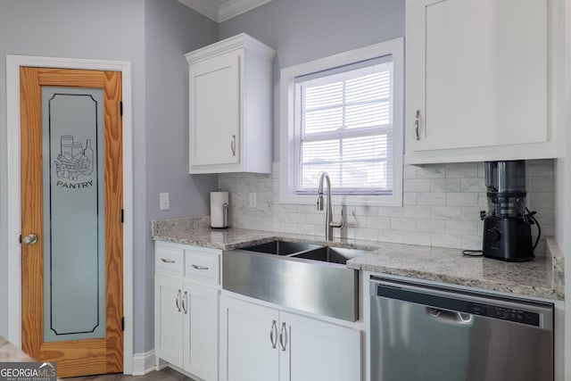 kitchen featuring white cabinets, dishwasher, backsplash, light stone countertops, and a sink