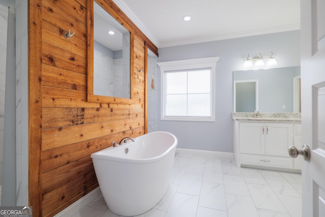 full bath featuring baseboards, marble finish floor, a freestanding tub, and crown molding