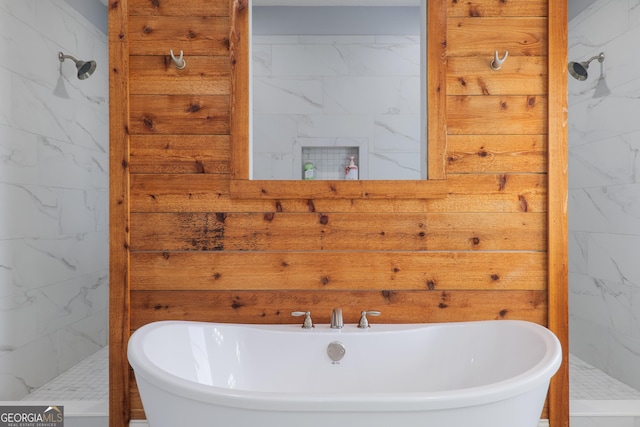 full bath with a freestanding bath and a marble finish shower