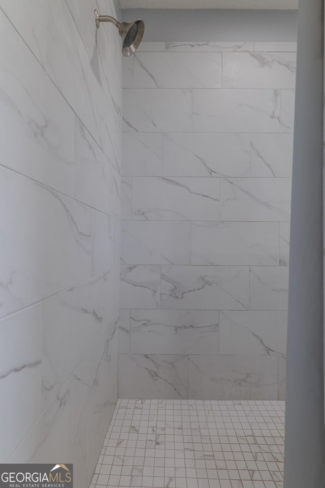 full bathroom with a tile shower