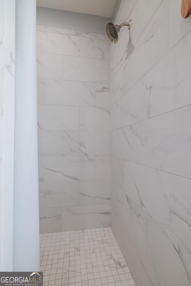 full bath with a tile shower