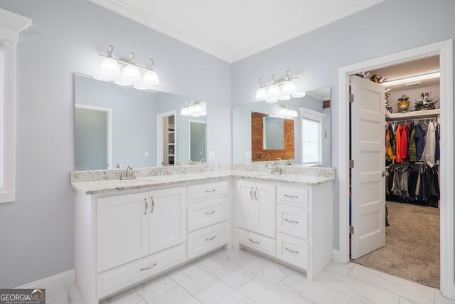 full bath featuring ornamental molding, marble finish floor, a spacious closet, and double vanity