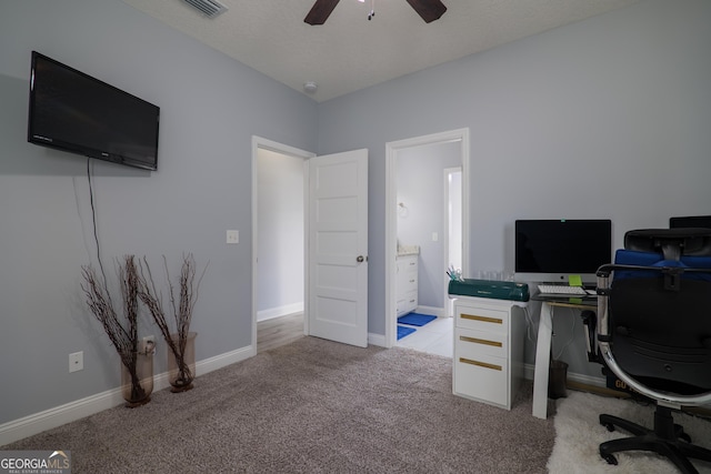 office area featuring visible vents, baseboards, light colored carpet, ceiling fan, and a textured ceiling