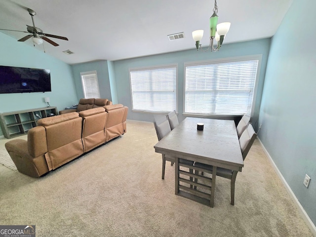 dining room with carpet floors, plenty of natural light, and visible vents