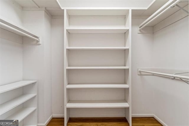 walk in closet featuring wood finished floors