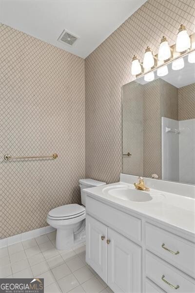 bathroom featuring toilet, tile patterned flooring, visible vents, and vanity