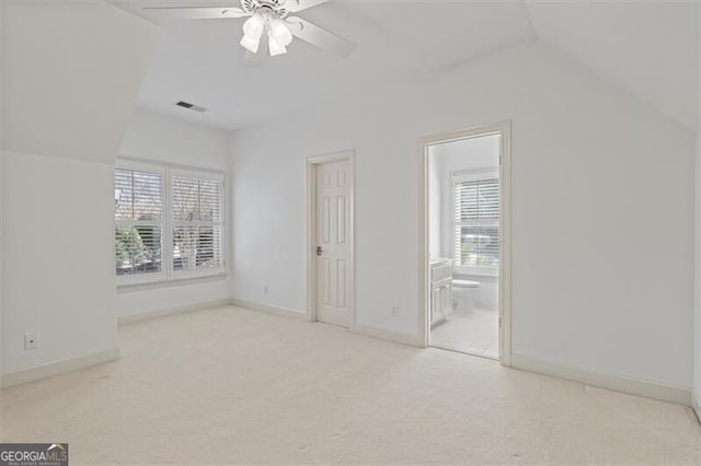 interior space featuring carpet, visible vents, and multiple windows