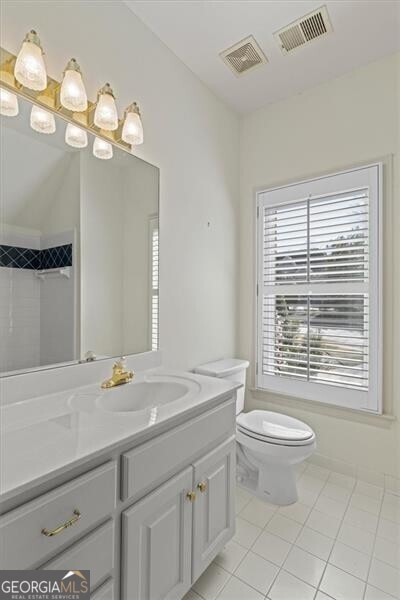 bathroom featuring visible vents, vanity, and toilet