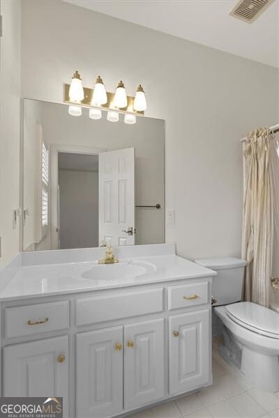 bathroom featuring toilet, tile patterned flooring, vanity, and visible vents