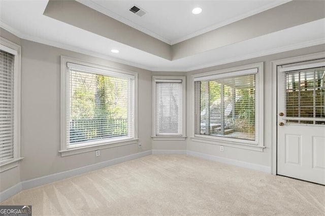 unfurnished room with recessed lighting, carpet floors, baseboards, a raised ceiling, and crown molding