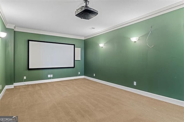 home theater with carpet, crown molding, and baseboards