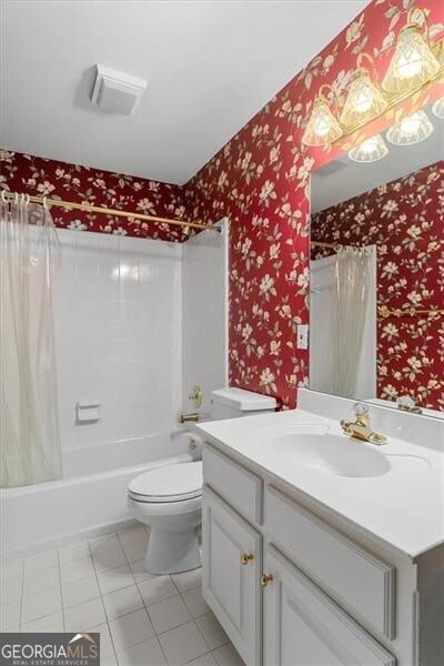 bathroom with wallpapered walls, shower / bathtub combination with curtain, toilet, vanity, and tile patterned floors