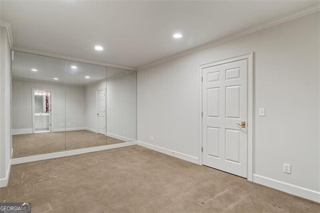 basement featuring carpet floors, recessed lighting, crown molding, and baseboards