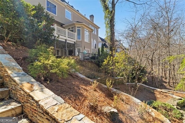 view of yard featuring a balcony