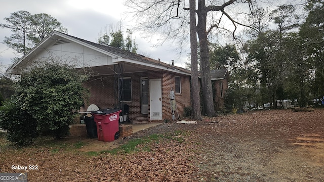 rear view of property with brick siding