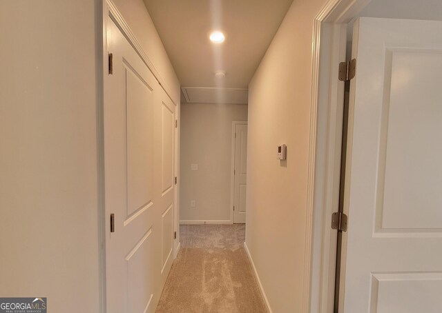 corridor with light carpet and baseboards