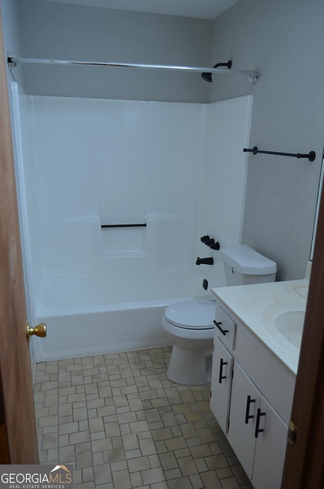 bathroom featuring toilet, vanity, and shower / bathtub combination