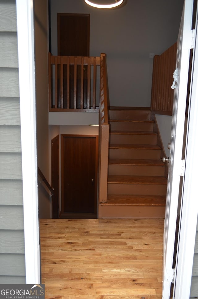 stairway with wood finished floors