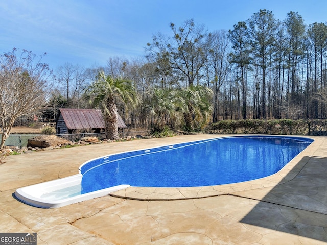 view of swimming pool with a fenced in pool and a patio