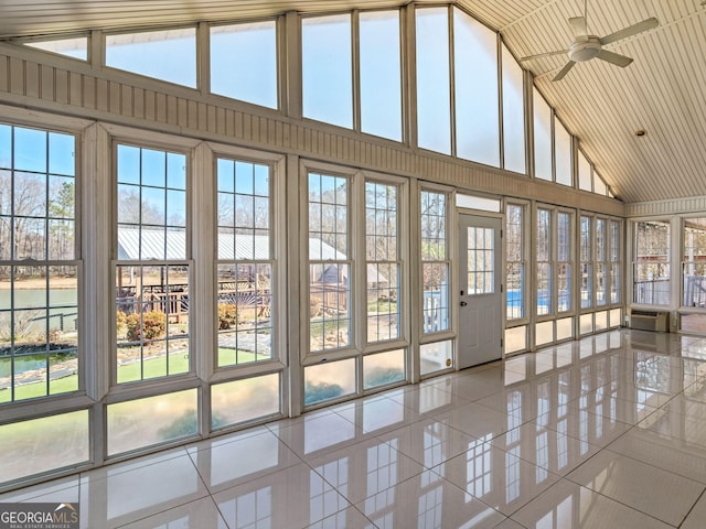 unfurnished sunroom featuring vaulted ceiling and a ceiling fan