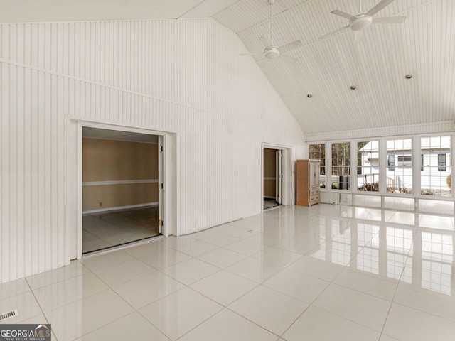 spare room featuring a ceiling fan, tile patterned flooring, and high vaulted ceiling