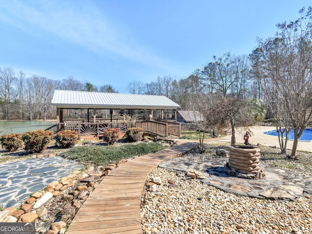 back of property featuring metal roof