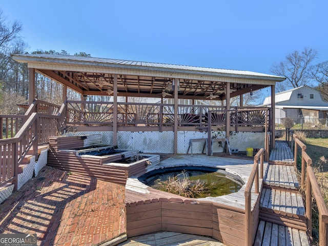 exterior space featuring a deck and a jacuzzi