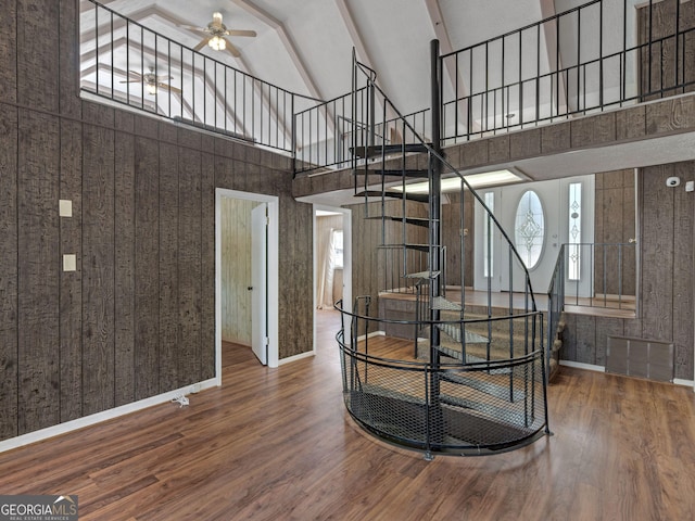 interior space featuring baseboards, ceiling fan, visible vents, and wood finished floors