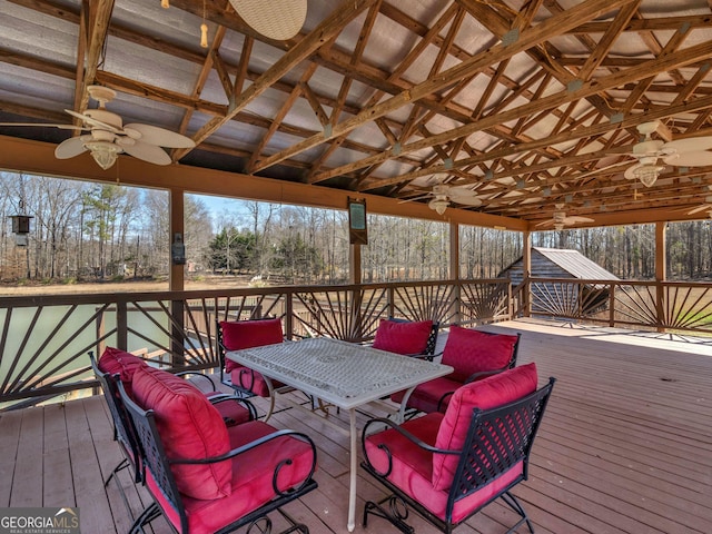 wooden terrace with a ceiling fan and a gazebo