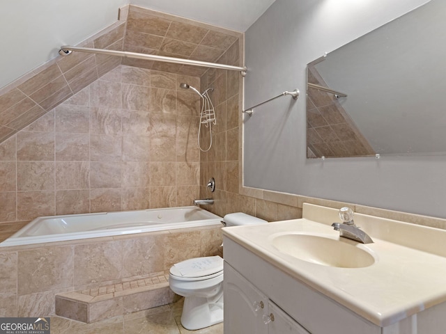 bathroom with tiled shower / bath combo, vanity, and toilet