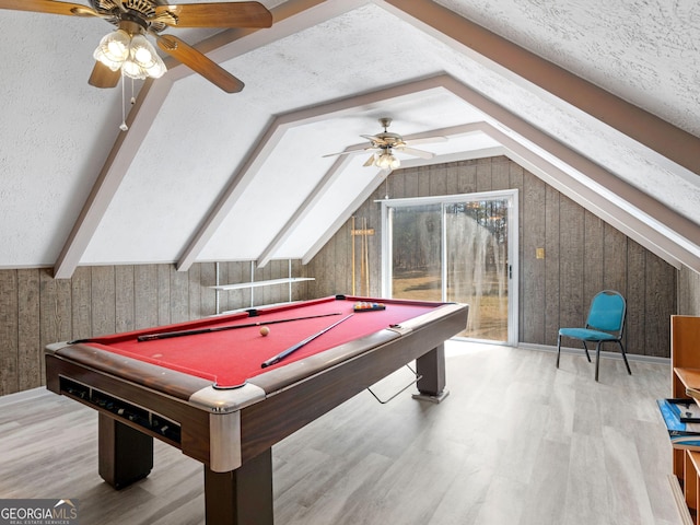 rec room featuring pool table, vaulted ceiling, a textured ceiling, and wood finished floors