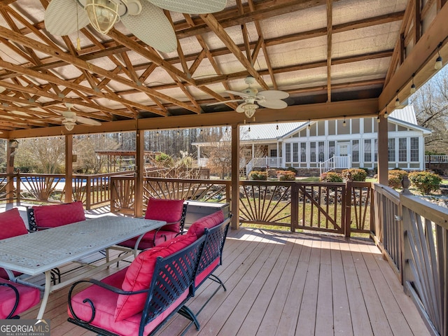 wooden deck featuring a ceiling fan