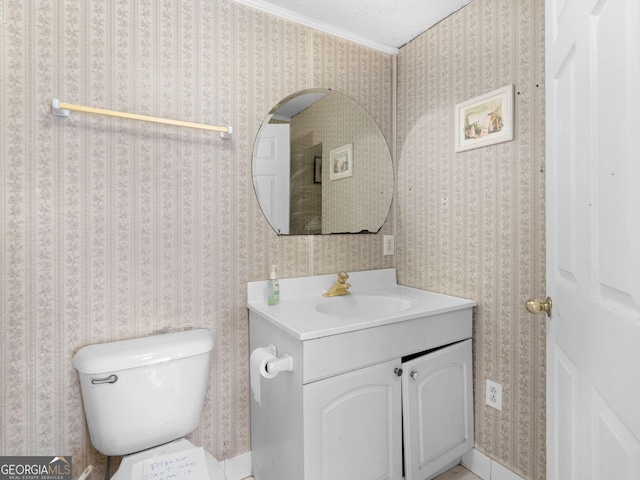 half bathroom with toilet, wallpapered walls, a textured ceiling, and vanity