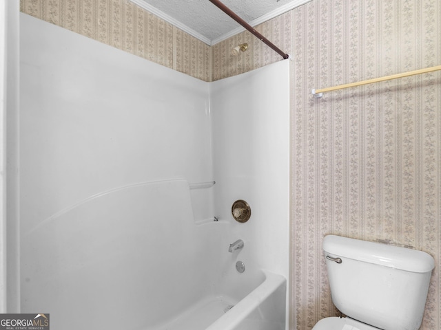 bathroom with a textured ceiling, crown molding, toilet, and wallpapered walls