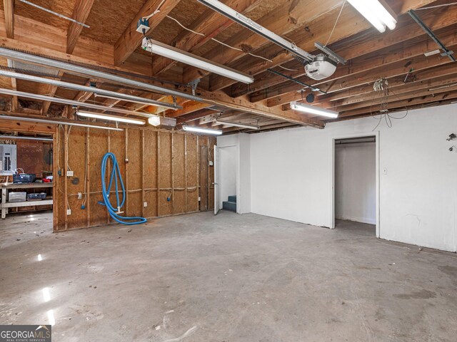 garage with electric panel and a garage door opener