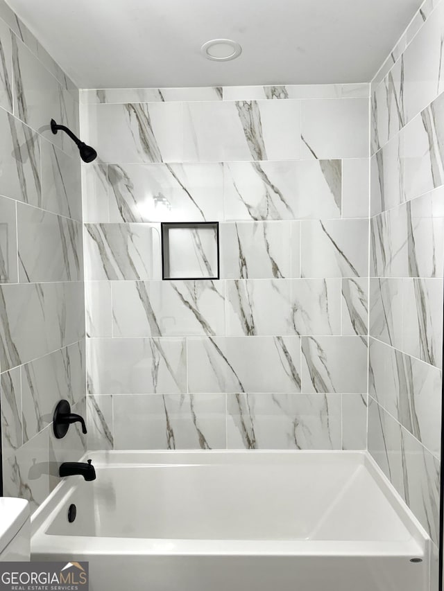 bathroom featuring toilet and shower / washtub combination