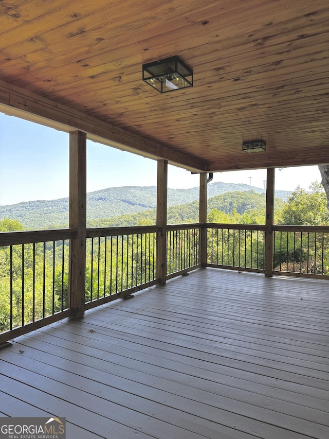 wooden deck featuring a mountain view