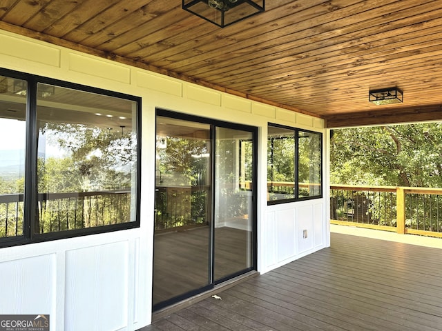 unfurnished sunroom featuring wood ceiling