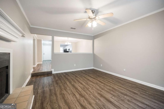 unfurnished living room featuring baseboards, ornamental molding, dark wood finished floors, and a tiled fireplace