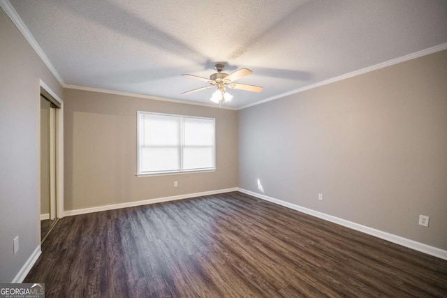 unfurnished bedroom with dark wood-style flooring, crown molding, ceiling fan, a textured ceiling, and baseboards