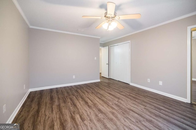 unfurnished bedroom featuring crown molding, baseboards, and wood finished floors